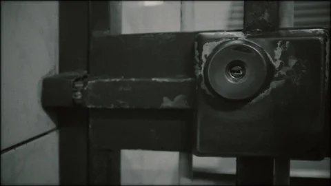 Communist Prison - the guard opens a sliding door Stock Footage 117932619