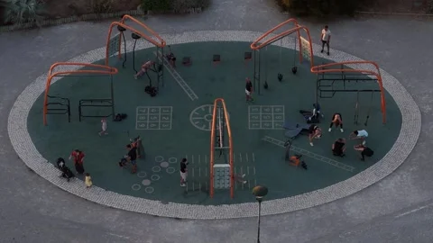 Community gathers at playground for fun and fitness activities in a vibrant park Stock Footage 315250083