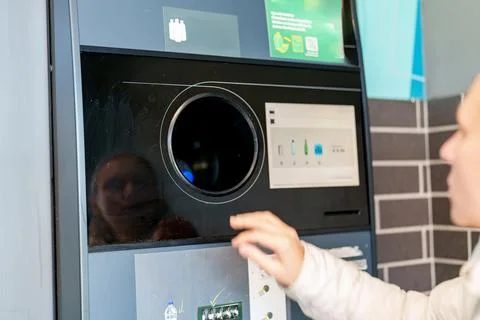 Community member using a recycling machine at a local center for waste mana.. 스톡 사진