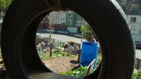 Community mural art project, framed by a tire swing Stock Footage 125539732