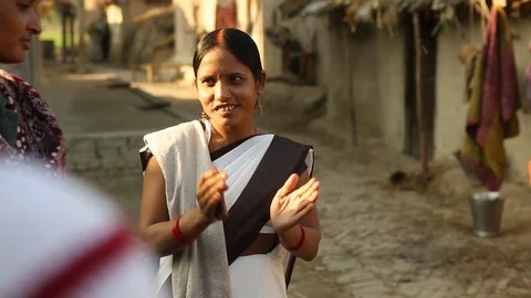 Community outreach health care worker (ASHA) talking with neighbors in India Stock Footage