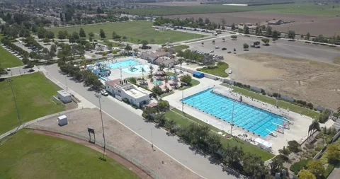 Community Pool &amp; Water Park next to Agriculture Fields (aerial) Видео 257375258