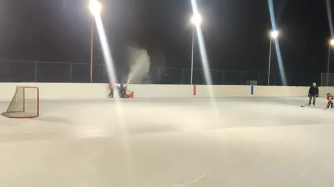 Community skating  ring snow cleaning Stock Footage 232195616