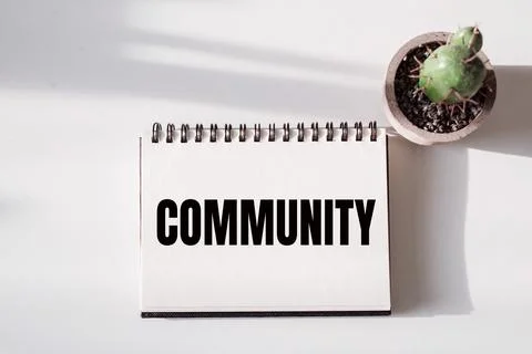 COMMUNITY text on a notepad with cactus on white background. Stock Illustration