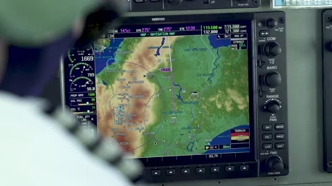 Commuter Cessna airplane Co-pilot manually programming position on GPS Stock Footage 229682453