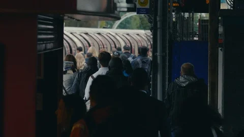 Commuter crowd walk along platform of tube station platform Stock Footage 88951187