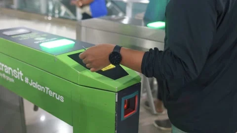 Commuter line passengers are tapping their cards to enter bekasi station. Stock Footage 221394589