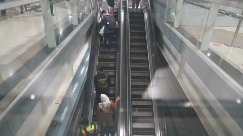 Commuter line passengers going up and down the escalator to change destinations. Stock Footage 221394659