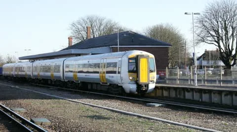 Commuter passenger train leaving railway station Stock Footage 10731078