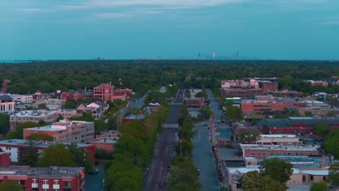 Commuter rail line through Highland Park, Illinois at dusk — downtown Stock Footage 339685590