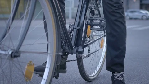 Commuter stopping for a moment while riding a bike Stock Footage 74638330