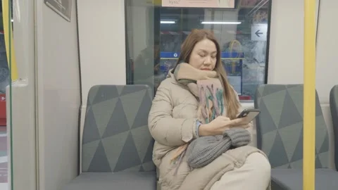 Commuter in a Subway Car Using Her Smartphone Stock-Footage 333449499