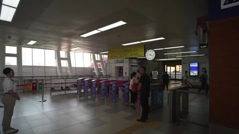 Commuter tapping cards to enter and quit the LRT Jabodebek station Stock Footage 255020027