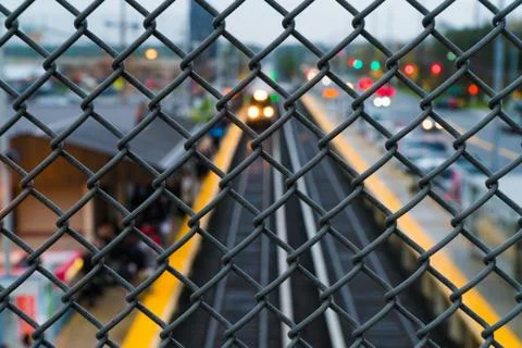 Commuter train arrives at station platform for passengers travel into work Stock Photos