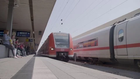 Commuter Train Arriving and Passing Through Busy Railway Platform with Waiting P Stock Footage 334054987
