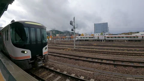 Commuter train arriving at a station platform in Takayama, Japan Stock-Footage 334061889