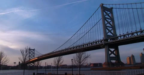 A commuter train crosses the Ben Franklin Bridge near Philadelphia, PA. Stock Footage