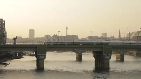 Commuter train crossing a bridge over the river Thames in London 스톡 동영상 61643635