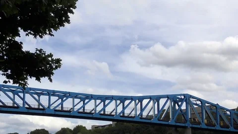Commuter train crossing girder bridge Stock Footage 79993146