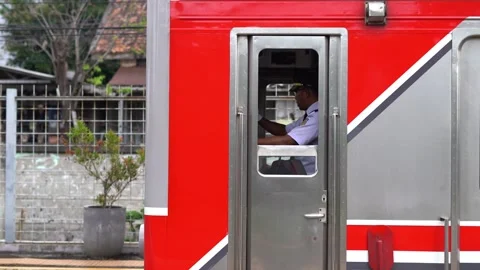 Commuter train drivers run their trains after the route is declared safe Stock Footage 300543236