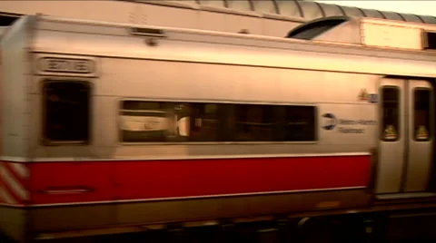 Commuter train goes by right to left away from camera pans, see electrical grid. Stock Footage 45868957