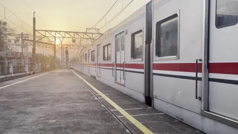 Commuter Train Leaving Railway Platform at Sunset Stock Footage 339327763