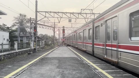 Commuter Train Leaving Station Platform at Sunset Stock Footage 336979684