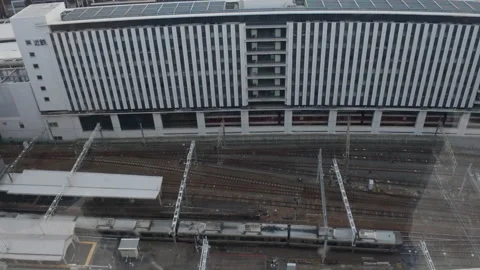 Commuter train moving along the tracks at a modern railway station in Japan Stock-Footage 333843050