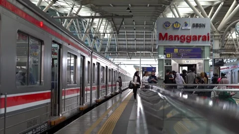 Commuter train passengers get off and board the train at a station Stock Footage 300544049