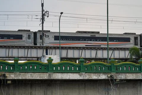 A commuter train passing on an elevated railway bridge. 스톡 사진