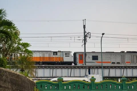 A commuter train passing on an elevated railway bridge. 스톡 사진