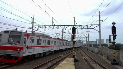 Commuter train passing the elevated train track at manggarai Stock Footage 300543334