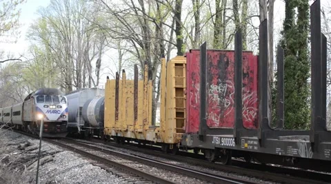 Commuter train passing freight train on side track Stock-Footage 50247049