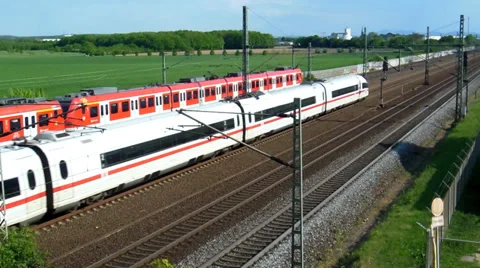 Commuter train passing by a high speed train Video stock 37428579