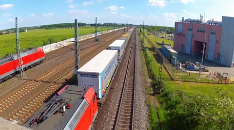 Commuter train passing by a high speed train and freight train Video stock 38290164