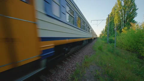 Commuter Train Passing by at High Speed | Ultra Wide Angle Close Up View of Rail Stock Footage 344894779
