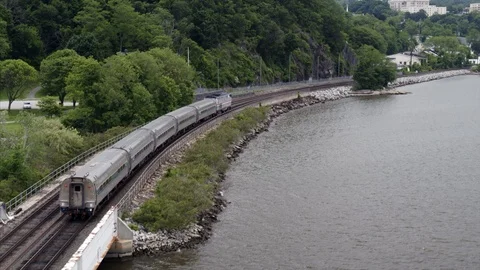 Commuter Train Passing by the Hudson River Aerial Stock Footage 94657470