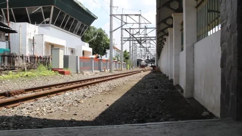 Commuter train passing through the suburbs on a sunny morning Stock Footage 272727039