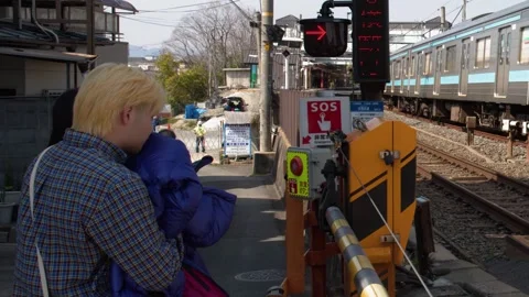 Commuter Train Passing Through Urban Railway Crossing in Kyoto Japan Stockbeeldmateriaal 337875545