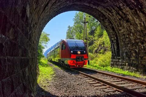 Commuter train pulls into tunnel Stock Photos