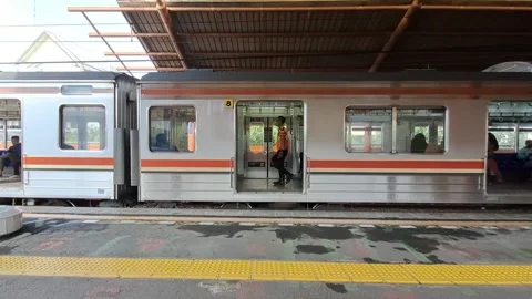 Commuter train stops at station Stock Footage 231472201