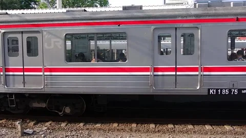 Commuter trains stop at a station to pick up and drop off passengers Stock Footage 288229179