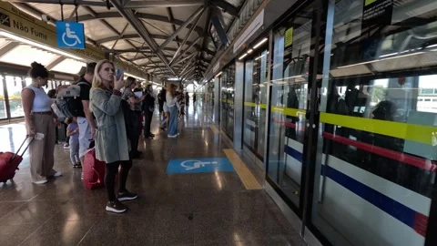 Commuters and passengers stand on the modern platform Stock-Footage 344355107