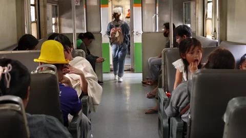Commuters and Passengers Traveling Inside a Vintage Thai Train Carriage Video stock 327710988