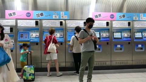 Commuters buying tickets at train ticket kiosks,Taipei, Taiwan. Stock Footage 254398713