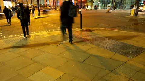 Commuters crossing a road at rush hour at night london england Video stock 101559061