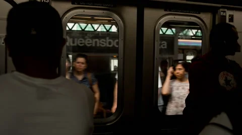 Commuters crowd of people enter MTA subway train in Queens in New York, USA Stock Footage 40240123