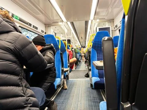 Commuters on a crowded train interior traveling through Liverpool, UK durin.. 스톡 사진