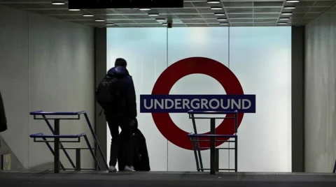 Commuters exit and enter the entrance to Kings Cross station 스톡 동영상 59737060