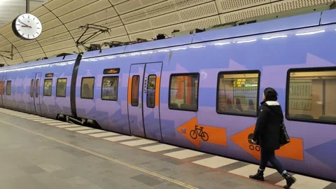 Commuters exit modern train at station platform, Malmo, Sweden Stock Footage 312722770
